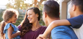 smiling-hispanic-family-with-parents-giving-childr-LVC733N